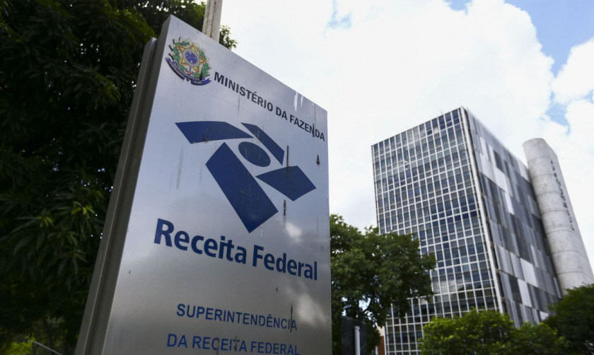 Painel eletrônico com dados fiscais ilustrando a arrecadação federal em setembro com alta puxada pelo petróleo.